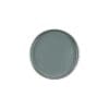 A round plate with a smooth, gray surface viewed from above, reminiscent of the sleek finish of GiGi Charcoal Detox Facial Hair Removal Wax.