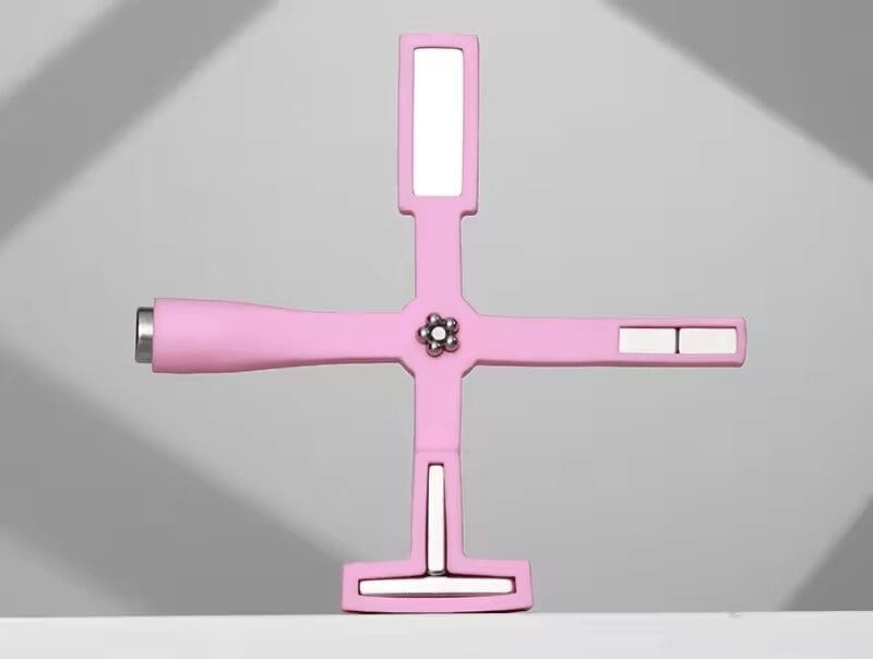 Pink multifunctional Cat Eye Magnet Stick with multiple ports in a cross shape.